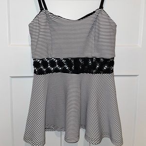 Size medium peplum black stripe top with removable and adjustable straps.